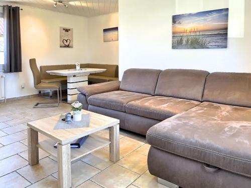 a living room with a couch and a table at Boddenwind No 2 in Zingst