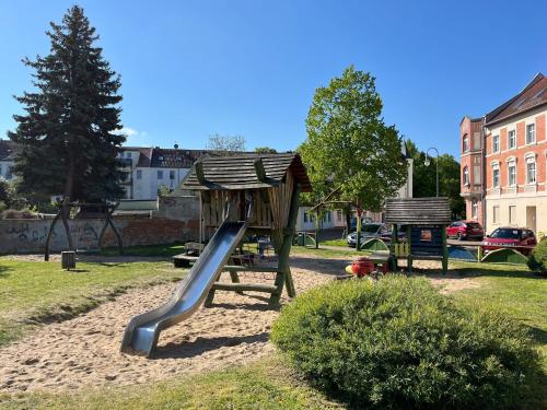 a playground with a slide in a park at Appartment Maxi 3 Personen, Zentrale Lage, ruhige Nebenstraße in Dessau