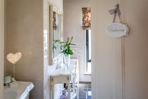 a bathroom with a sink and a mirror at Doleen House in Ballyconneely