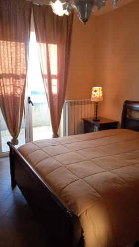 a bedroom with a large bed and a window at B&B Serena in Casapulla