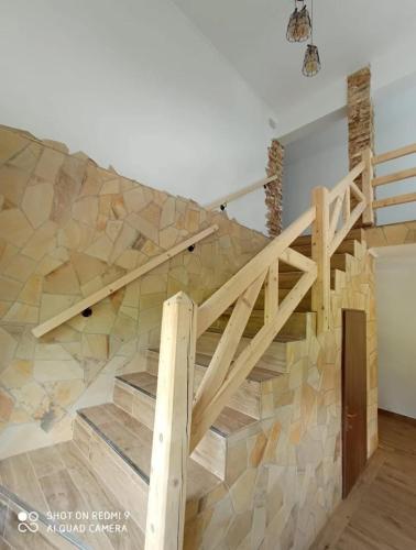 a staircase in a house with a mosaic wall at La Lacuri in Sovata