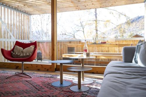 a living room with a couch and a chair and a table at Chasa 5 in Scuol