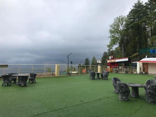 a group of tables and chairs sitting on a field at BULAND HEIGHTS in Murree