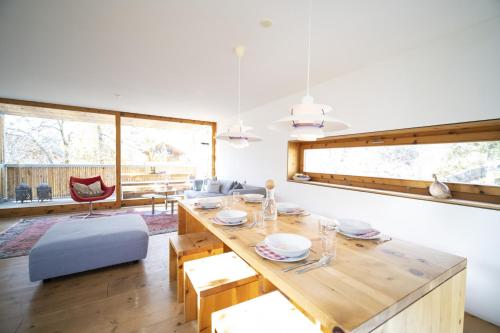 a dining room with a large wooden table and chairs at Chasa 5 in Scuol