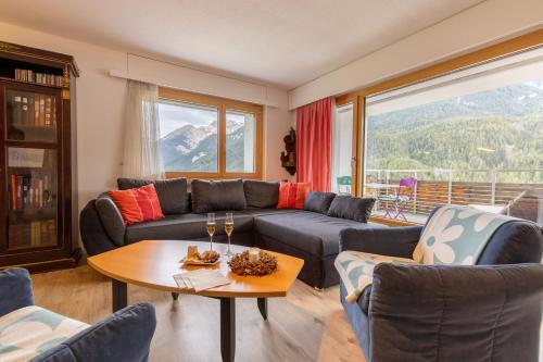 a living room with a couch and a table at Chasa Vista Lischana in Scuol