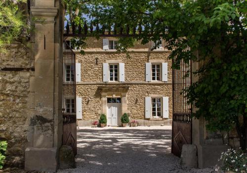 an entrance to a stone building with a gate at La Moutière in Colonzelle