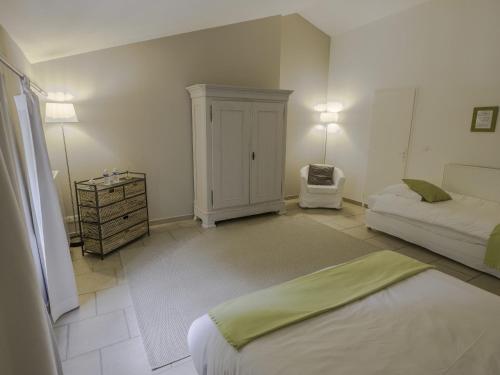 a bedroom with a bed and a dresser in it at La Moutière in Colonzelle