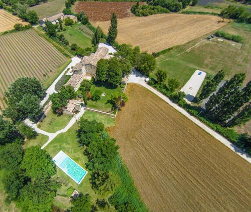 an aerial view of a farm with a house and a pool at La Moutière in Colonzelle