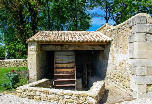 a small stone building with a staircase in it at La Moutière in Colonzelle