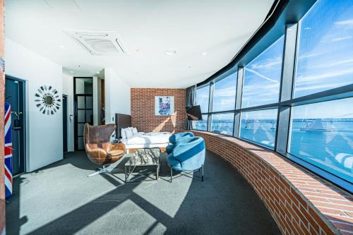 a balcony with a table and chairs in a building at H Avenue Hotel Gwangalli branch in Busan