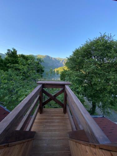 a wooden boardwalk with a view of a mountain at Agora Farmhouse in Koman