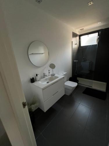 a bathroom with a sink and a toilet and a mirror at Luxury corner villa 3BR COSTA BLANCA in Alicante