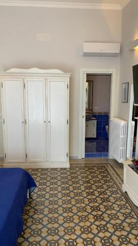 a bedroom with a bed and white cabinets at villa verde sul mare in Vietri sul Mare