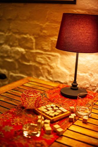 a table with a lamp and a plate of food at Schlosshotel Ziethen in Kremmen