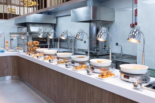 a kitchen with several bowls of food on a counter at Belenli Resort Hotel in Belek