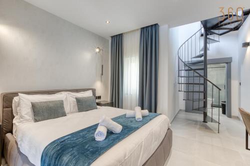 a bedroom with a bed with slippers on it at The ultimate luxury triplex home in Spinola Bay by 360 Estates in St Julian's