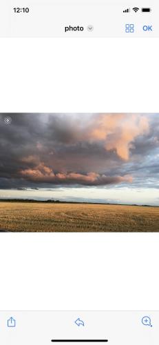 two photographs of a cloudy sky and a field at L‘Embellie in Moussey