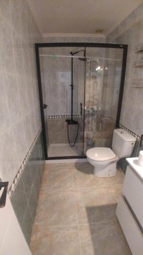 a bathroom with a shower and a toilet in it at ALOJAMIENTO EN CULLERa in Cullera