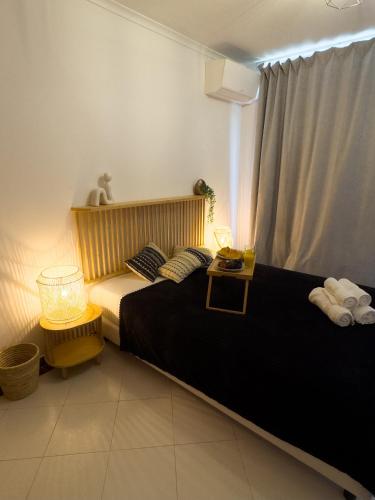 a bedroom with a bed and a window with two lamps at Penthouse Ocean View Sesimbra - parking @center in Sesimbra