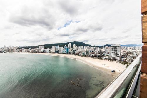a view of a beach and a city at H Avenue Hotel Gwangalli branch in Busan