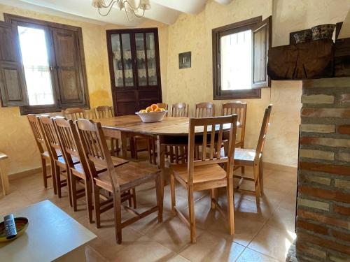 a dining room with a wooden table and chairs at Casas Amarillas. Finca el Campillo in Blanca