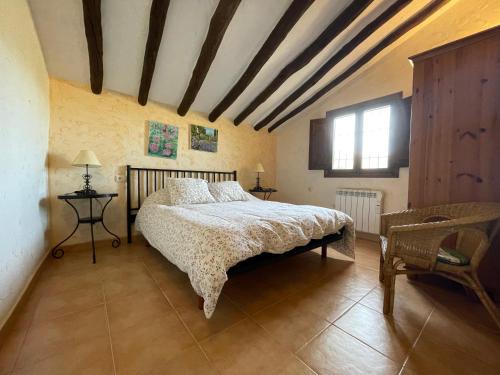 a bedroom with a large bed and a window at Casas Amarillas. Finca el Campillo in Blanca