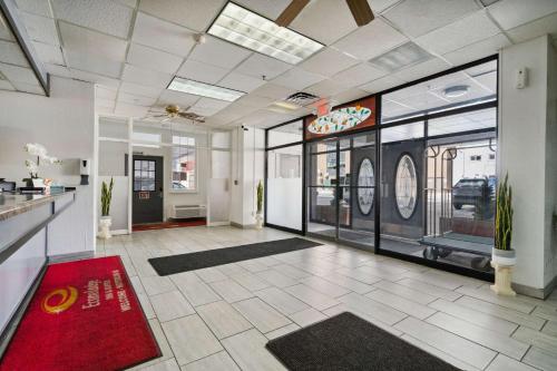 a lobby of a restaurant with a red rug at Econo Lodge Inn & Suites in Waterloo