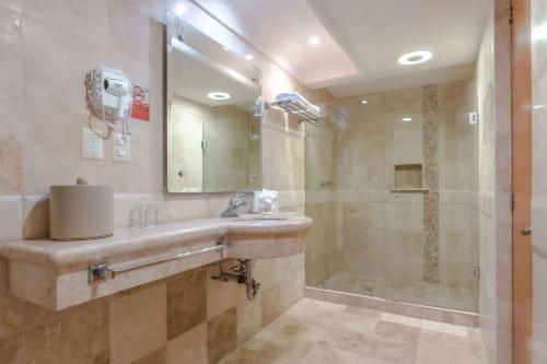 a bathroom with a sink and a shower at Quality Inn Mazatlan in Mazatlán