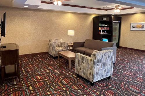 a living room with couches and chairs in a hotel room at Quality Suites Midland North Loop 250 in Midland