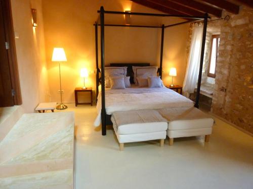 a bedroom with a large bed and two lamps at Casa 3 Leones in Llombarts