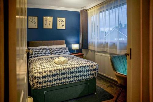 1 dormitorio con cama y ventana en Raku House Ashford 5 beds - sleep 8 - Free parking and Wifi - Prime location for Families and Contractors, en Ashford