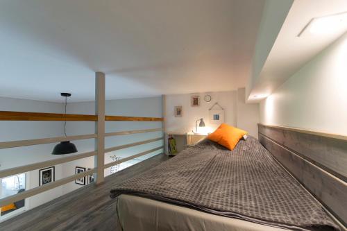 1 dormitorio con 1 cama grande con almohada naranja en Apartament Rekowo en Kamień Pomorski