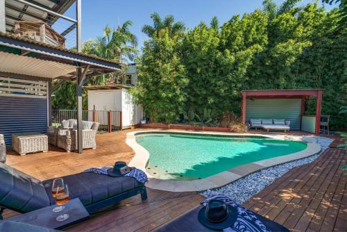 a swimming pool in the backyard of a house at Battery Hill Pet-Friendly Poolside Paradise in Caloundra