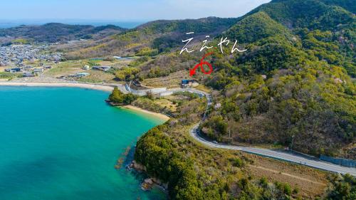 an aerial view of a road next to a body of water at 4S resort eeyan in Ikisue