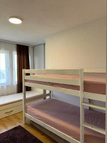a bedroom with two bunk beds and a window at Villa Arisi in Pristina
