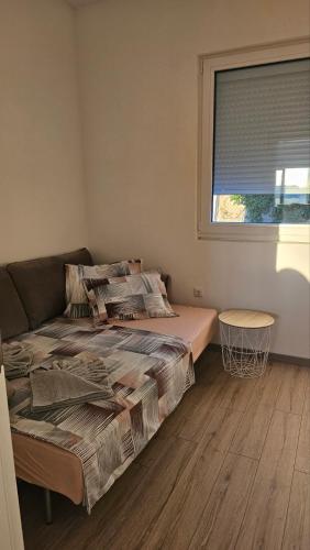 a bedroom with a bed and a window at Apartments Radoman in Ulcinj