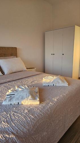 a bedroom with two beds with white cabinets at Apartments Radoman in Ulcinj