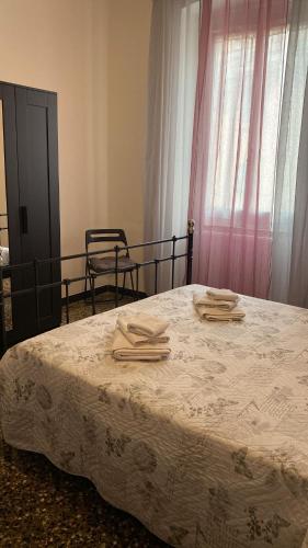 a bedroom with a bed with towels on it at Casa Sole E Luna in Genova