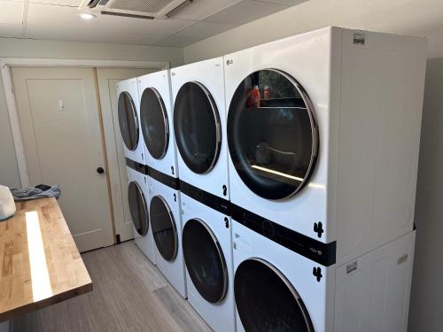 a row of washing machines in a laundry room at Seaside Escape A Cozy Houseboat in Merritt Island