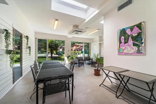 a dining room with two tables and chairs at Villa Rita in Domaso