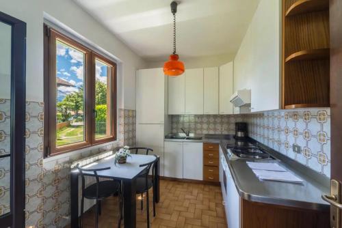 a kitchen with a table and a counter top at Villa Rita in Domaso