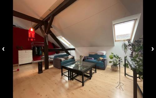 a living room with a blue couch and a table at Spring Cuddle Nest in Berlin