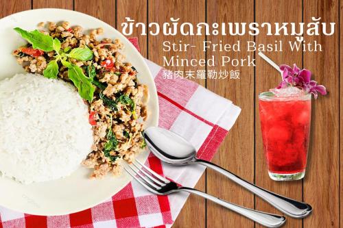 a plate of food with rice and a drink at Grand Sansook Omnoi in Ban Khlong Om Noi