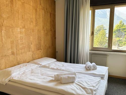 a bedroom with two beds with towels on them at Residence Monica in Riva del Garda