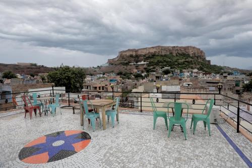 a table and chairs on a balcony with a view at Borunda Heritage Haveli in Jodhpur