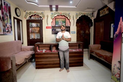 a man standing in a room with his arms crossed at Borunda Heritage Haveli in Jodhpur