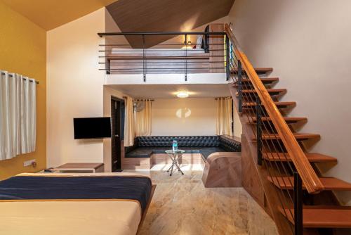 a room with a staircase with a bed and a couch at The Venue By Seasons Suites- in Dod Ballāpur