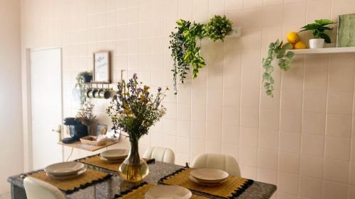 a dining room table with a vase of flowers on it at Casa Bienvenida in Bienvenida