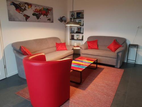 a living room with two couches and a table at Fewo Storchennest in Kollmar