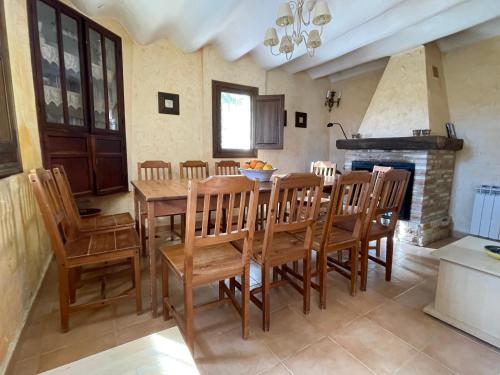 a dining room with a wooden table and chairs at Casas Amarillas. Finca el Campillo in Blanca